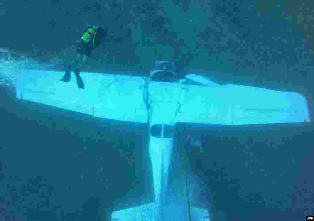 Lebanese divers inspect the sunken wreckage of a Cessna 172 training aircraft that crashed two days ago off the coastal town of Halat, north of the capital Beirut, in this handout picture released by the Lebanese Army Press office.