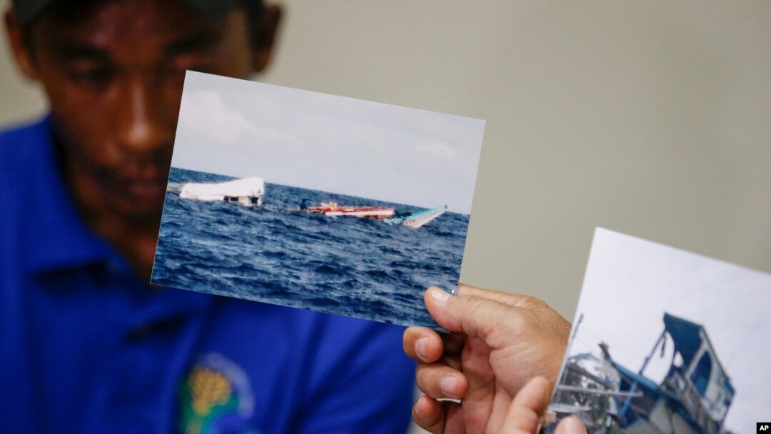 Photos of the damaged Filipino fishing vessel F/B Gimver 1 is shown next to one of its crew Richard Blaza during a press conference by Department of Agriculture Secretary Emmanuel Pinol in metropolitan Manila, Philippines, June 17, 2019.