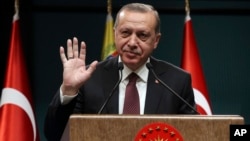 Turkey's President Recep Tayyip Erdogan gestures during a joint press conference with Venezuela's President Nicolas Maduro, following their meeting at the Presidential Palace in Ankara, Turkey, Oct. 6, 2017. 