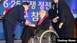 정홍원 한국 국무총리가 27일 서울에서 열린 '제61주년 정전협정 및 유엔군 참전의 날' 기념식에서 에드워드 라우니 중장에게 태극무공훈장을 수여한 뒤 손을 잡고 있다. 