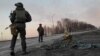 Service members of the Ukrainian armed forces stand next to a tripod-mounted missile system outside Kharkiv on February 24, 2022. (Maksim Levin/Reuters)