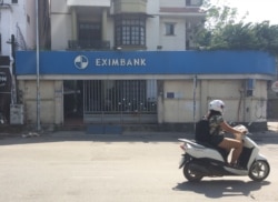 A motorbike driver rides past a branch of Eximbank in Ho Chi Minh City. (H. Nguyen/VOA)