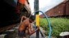 Prakash Nagre washes himself at Aurangabad railway station, Aurangabad India, August 2, 2019. Nagre carries soap and shampoo to have a bath at the railway station. "There's no water to bathe at home," he said. REUTERS/Francis Mascarenhas SEARCH …