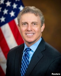 FILE - Special Counsel of the U.S. Office of Special Counsel Hampton Dellinger poses for a portrait in an undated handout image.