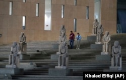 Visitors walk past ancient Egyptian statues along the Grand Staircase at the Grand Egyptian Museum in Giza, Egypt, Tuesday, Oct.15, 2024. (AP Photo/Khaled Elfiqi)