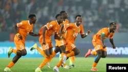 Ivory Coast players celebrate after winning the Round of 16 match against Senegal at the 2023 Africa Cup of Nations, Charles Konan Banny Stadium, Yamoussoukro, January 29, 2024 