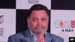FILE - Bollywood actor Rishi Kapoor greets the media as he arrives for the song launch of the film '102 Not Out,' in Mumbai, India, April 19, 2018. He died Thursday at age 67.