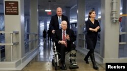FILE - Sen. John McCain heads to the Senate floor ahead of votes on Capitol Hill in Washington, U.S., Dec. 6, 2017. 