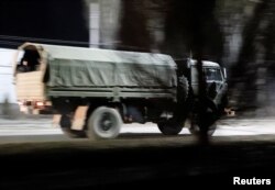 A military truck drives along a street in the separatist-controlled city of Donetsk, Ukraine Feb. 22, 2022, after Russian President Vladimir Putin ordered the deployment of Russian troops to two breakaway regions in eastern Ukraine following the recognition of their independence.