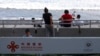 FILE - A sign reading in Spanish 'Assistance from China, for a shared future' is part of the remodeling work in the area of the boardwalk on the pier in La Libertad, El Salvador, June 18, 2021.