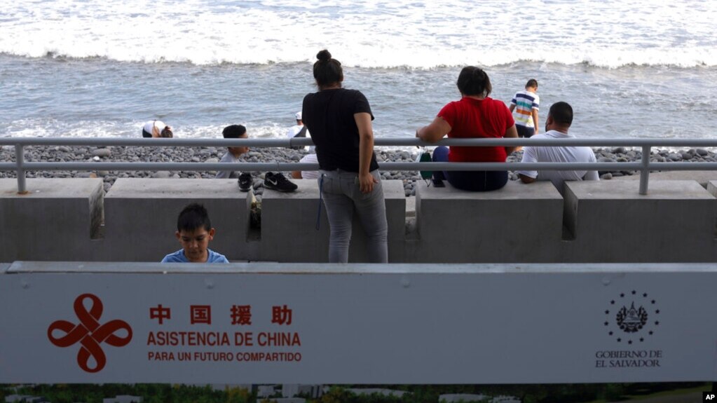FILE - A sign reading in Spanish 'Assistance from China, for a shared future' is part of the remodeling work in the area of the boardwalk on the pier in La Libertad, El Salvador, June 18, 2021.