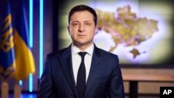 In this photo provided by the Ukrainian Presidential Press Office, Ukrainian President Volodymyr Zelenskyy addresses the nation on a live TV broadcast in Kyiv, Ukraine, Tuesday, Feb. 22, 2022.
