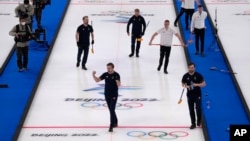 Team Sweden celebrates their win during the men's curling final match between Britain and Sweden at the Beijing Winter Olympics, Feb. 19, 2022, in Beijing.