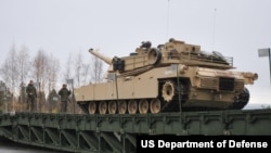 FILE - An M1 Abrams crosses a bridge in Hell, Norway, Oct. 21, 2018, during a military exercise.