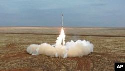 This photo taken from video provided by the Russian Defense Ministry Press Service Feb. 19, 2022, shows a Russian Iskander-K missile launched during a military exercise at a training ground in Russia. 