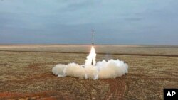 This photo taken from video provided by the Russian Defense Ministry Press Service Feb. 19, 2022, shows a Russian Iskander-K missile launched during a military exercise at a training ground in Russia. 