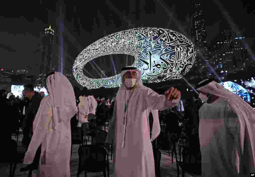 People leave after the opening ceremony of the Museum of the Future, a show space for futuristic ideas, in Dubai, United Arab Emirates.
