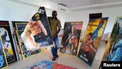 Ghanaian popular culture anthropologist Joseph Oduro-Frimpong, 45, displays his private collection of hand-painted movie posters at the Center for African Popular Culture at Ashesi University in Berekuso, Ghana, Feb. 12, 2022.