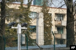 A pillar inscribed with a homage of North Korea's former leaders Kim Il Sung and Kim Jong Il stands in the courtyard of the North Korean Embassy in Beijing, China, Feb. 17, 2022.