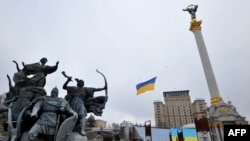 FILE - A drone carries a Ukrainian National flag above the Independence Square to mark a "Day of Unity" in Kyiv, Feb. 16, 2022. 