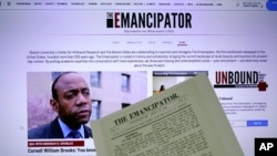 The new online publication of "The Emancipator" is pictured with a copy of the April 30, 1820, first edition of "The Emancipator", Feb. 2, 2022, in Boston. 