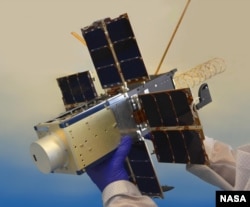 This file photo shows NASA's NACHOS instrument, held by a researcher. The instrument is designed to observe gases like sulfur dioxide and nitrogen dioxide, which could help predict volcanic activity. (Photo Credit: Los Alamos National Laboratory/Logan Ott/NASA)