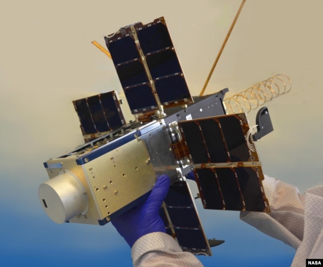 This file photo shows NASA's NACHOS instrument, held by a researcher. The instrument is designed to observe gases like sulfur dioxide and nitrogen dioxide, which could help predict volcanic activity. (Photo Credit: Los Alamos National Laboratory/Logan Ott/NASA)