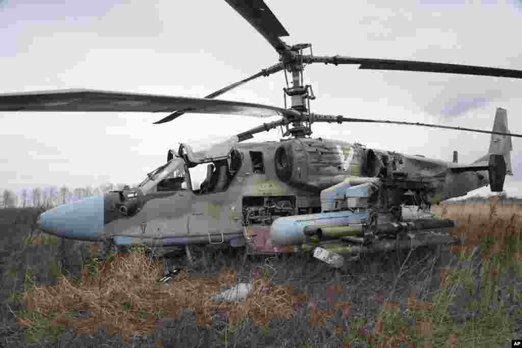 A Russian Ka-52 helicopter gunship is seen in the field after a forced landing outside Kyiv, Ukraine, Feb. 24, 2022.