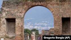 Tourists walk inside the Pompeii archaeological site in southern Italy, Feb. 15, 2022. (AP Photo/Gregorio Borgia)