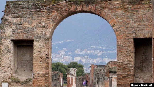 Tourists walk inside the Pompeii archaeological site in southern Italy, Feb. 15, 2022. (AP Photo/Gregorio Borgia)