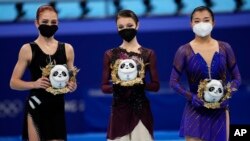 From left, silver medalist, Alexandra Trusova, of the Russian Olympic Committee (ROC), gold medalist, Anna Shcherbakova, of the ROC, and bronze medalist, Kaori Sakamoto, of Japan, pose after the women's figure skating competition at the 2022 Winter Olympi