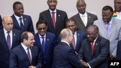 FILE - Russian President Vladimir Putin shakes hands with South African President Cyril Ramaphosa prior to a family photo with heads of countries taking part in the 2019 Russia-Africa Summit in Sochi, Oct. 24, 2019. (Photo by Sergei Chirikov/Pool/AFP)