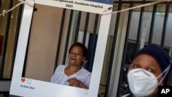 FILE - Maggie Sedidi, a nurse, poses for a photo taken after receiving a dose of the COVID-19 vaccine in Soweto, South Africa, March 5, 2021.