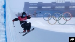 Britain's Gus Kenworthy falls during the men's halfpipe finals at the 2022 Winter Olympics, Saturday, Feb. 19, 2022, in Zhangjiakou, China.