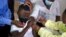 FILE - A child gets a vaccine against COVID-19 in Diepsloot Township near Johannesburg, Oct. 21, 2021.