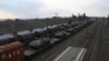Russian armored vehicles are loaded onto railway platforms at a railway station in region not far from Russia-Ukraine border, in the Rostov-on-Don region, Russia, Feb. 23, 2022. 