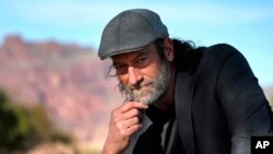 Troy Kotsur, nominated for an Oscar for best supporting actor for his role in the film "CODA," poses for a photo at Red Rock Park in Mesa, Ariz., on Jan. 28, 2022. (AP Photo/Matt York)