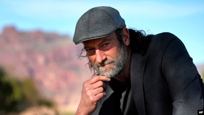 Troy Kotsur, nominated for an Oscar for best supporting actor for his role in the film "CODA," poses for a photo at Red Rock Park in Mesa, Ariz., on Jan. 28, 2022. (AP Photo/Matt York)