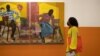 A visitor looks at artwork in this undated image taken from the Investec Cape Town Art Fair Facebook page. The event opened at the Cape Town International Convention Centre on Feb. 18, 2022.