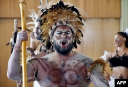 A Rapa Nui native performs at the Natural History Museum in Santiago, on Feb. 21, 2022, before the Moai Tau, a statue from Easter Island, is returned.