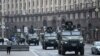 Ukrainian military vehicles move past Independence square in central Kyiv on Feb. 24, 2022.