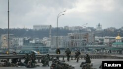 Servicemen of the Ukrainian National Guard take positions in central Kyiv, after Russia launched a massive military operation against Ukraine, Feb. 25, 2022. 