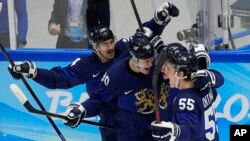Finland celebrates a goal by Ville Pokka during the men's gold medal hockey game against the Russian Olympic Committee at the 2022 Winter Olympics, Feb. 20, 2022, in Beijing. 