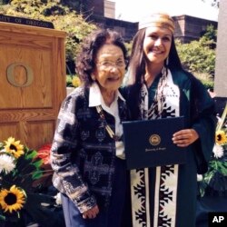 In this 2014 photo provided by Gary Risling, Emmilee Risling, right, poses after her graduation from the University of Oregon in Eugene, Ore., with her great-aunt and adoptive grandmother Viola Risling-Ryerson.