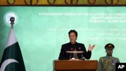 FILE - Pakistan Prime Minister Imran Khan, center, speaks during the extraordinary session of Organization of Islamic Cooperation Council of Foreign Ministers, in Islamabad, Pakistan, Dec. 19, 2021. 