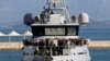 Penumpang yang diselamatkan dari Euroferry Olympia berbendera Italia, yang terbakar di Pulau Corfu, terlihat di atas kapal Guardia di Finanza di pelabuhan, Yunani, 18 Februari 2022. (REUTERS/Giorgos Korkidis)