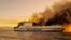 A ferry burns in the Ionian Sea near the island of Corfu, Greece, Feb. 18, 2022. The ferry caught fire overnight, while heading to southern Italy, authorities said.