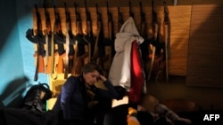 People hide in a bomb shelter in Kyiv, Ukraine, in the early hours of February 25, 2022.