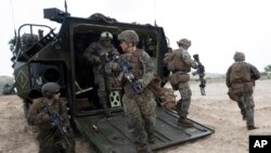 FILE - U.S. soldiers land with an amphibious assault vehicle on the beachhead during U.S.-Thai "Cobra Gold" joint military exercises on Hat Yao beach in Chonburi province, eastern Thailand, Feb. 28, 2020.