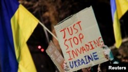 A person holds up a placard during a pro-Ukrainian demonstration outside the Russian Embassy, in London, Britain, Feb. 23, 2022. 